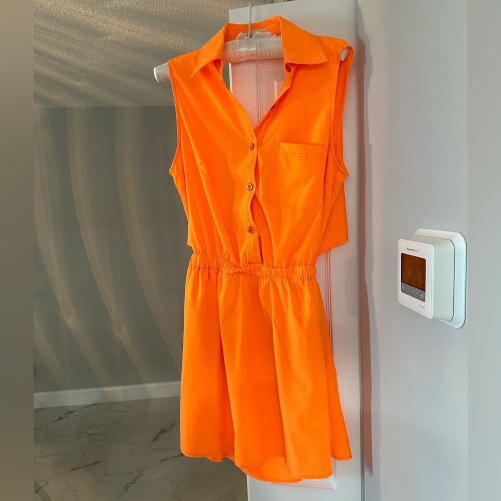 Gorgeous bright orange dress. Partially backless. 3 pockets. new. Fits M or L